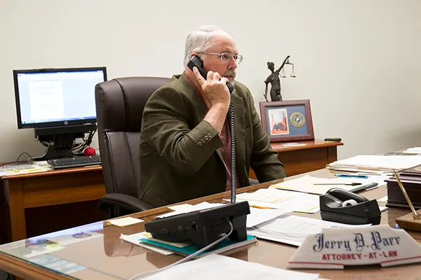 man on phone at desk