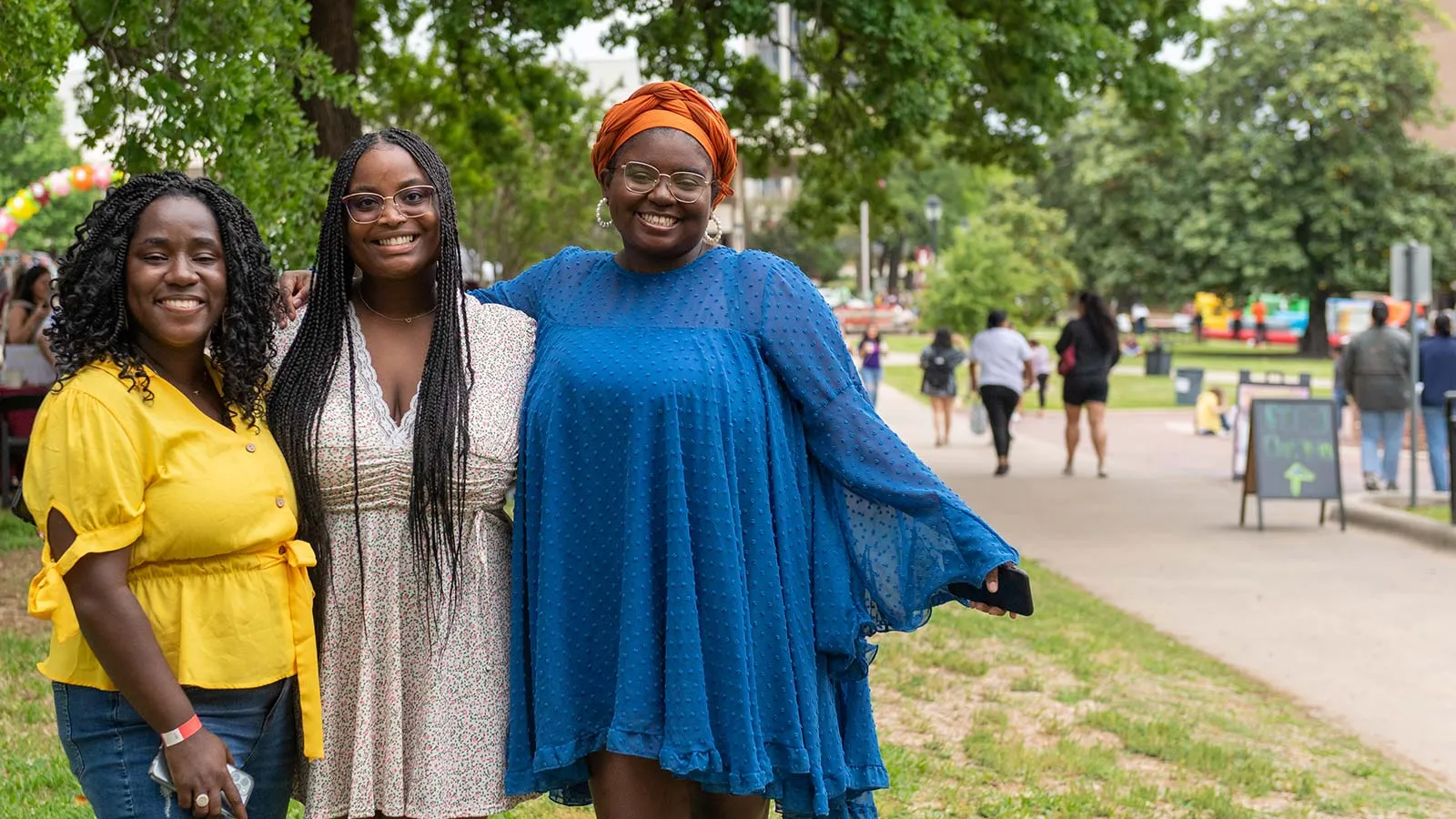 Three prospective students enjoy the Denton campus with their tour group