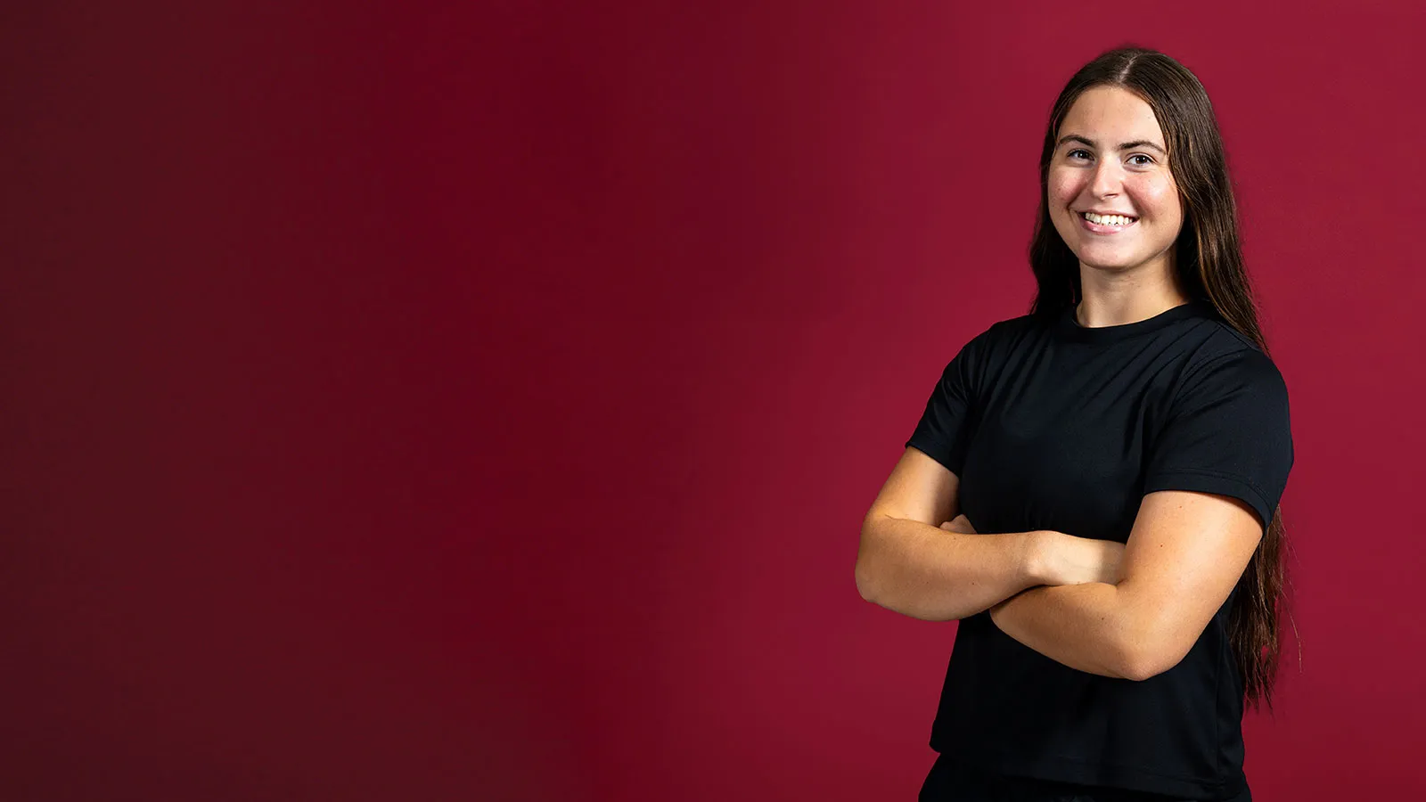 TWU student Adriana Mauldin stands with arms crossed confidently