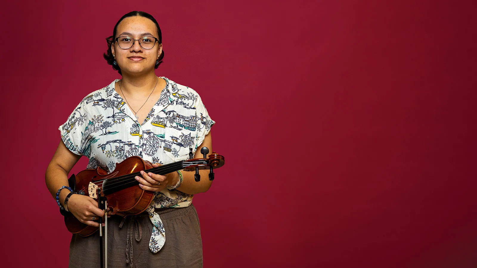 TWU student Alexandra Graciano stands with her violin