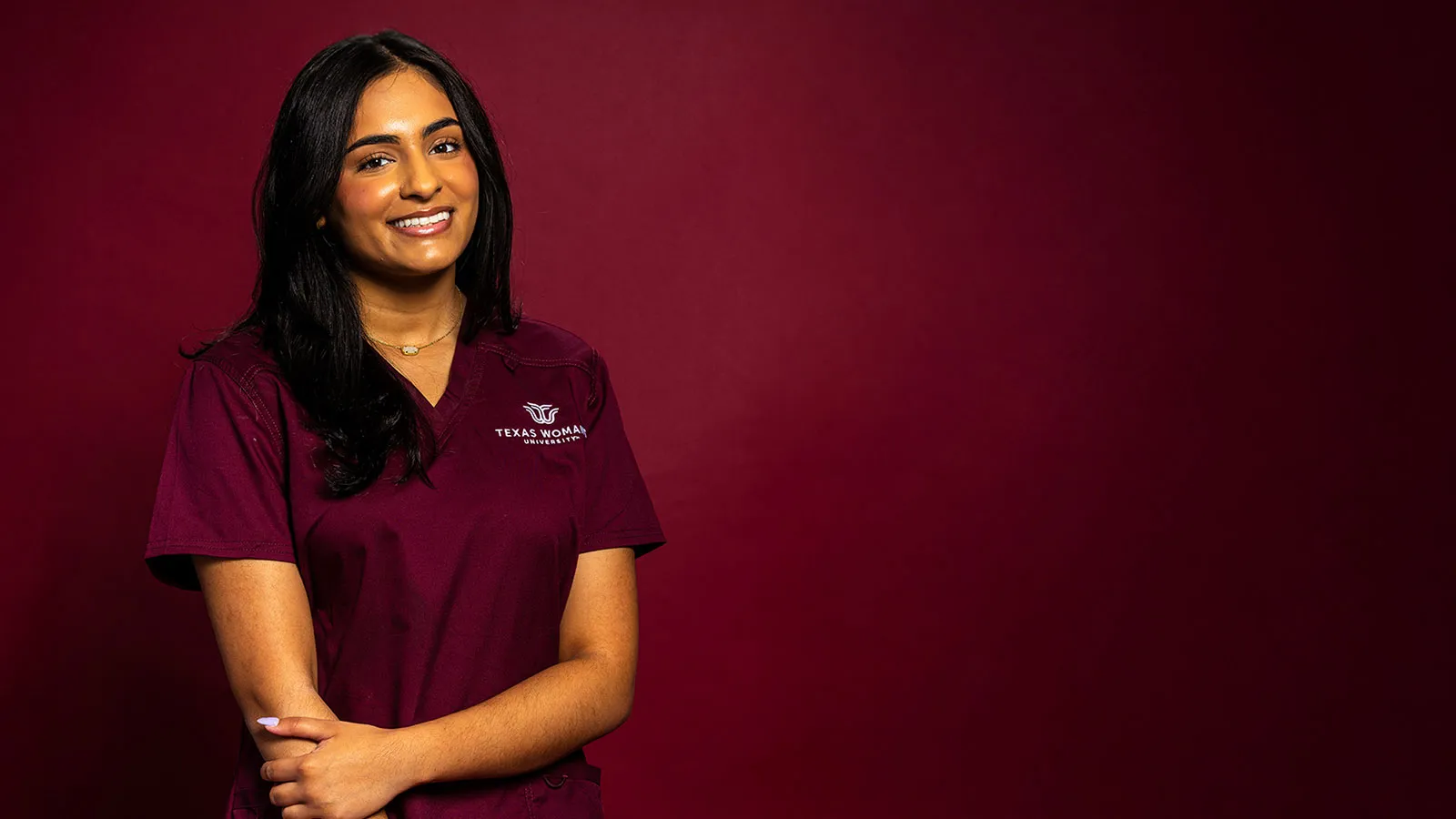 TWU Nursing student Anjali Bhatt wearing maroon scrubs