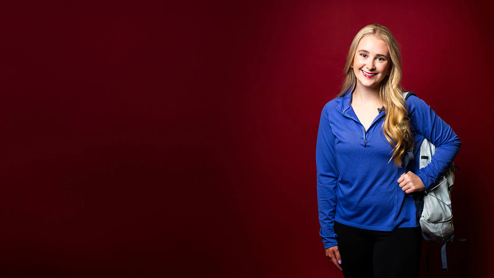ӽstudent Claire Butler dressed casually with a backpack over her shoulder