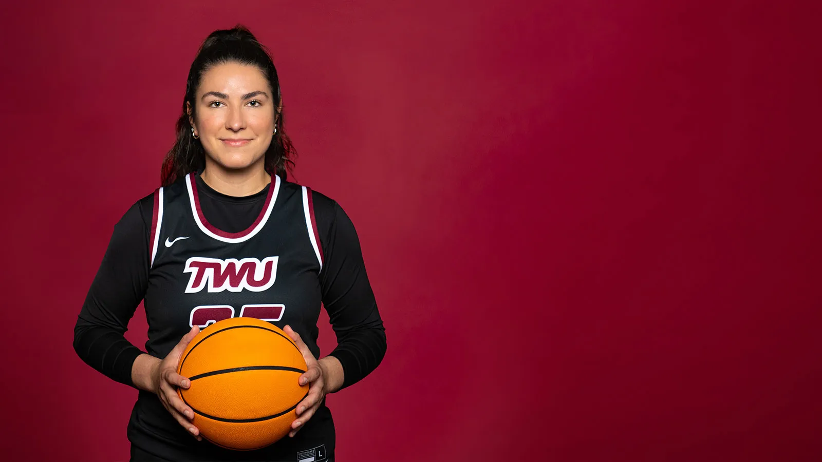 A TWU Student Holding a Basketball