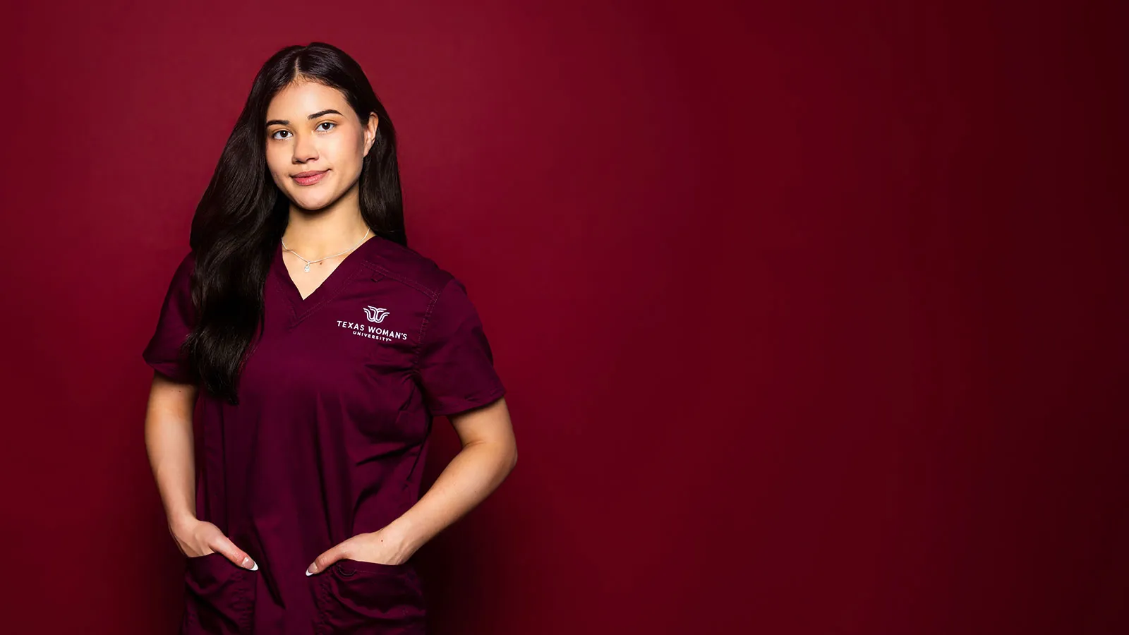 A TWU Student in Maroon Nursing Scrubs