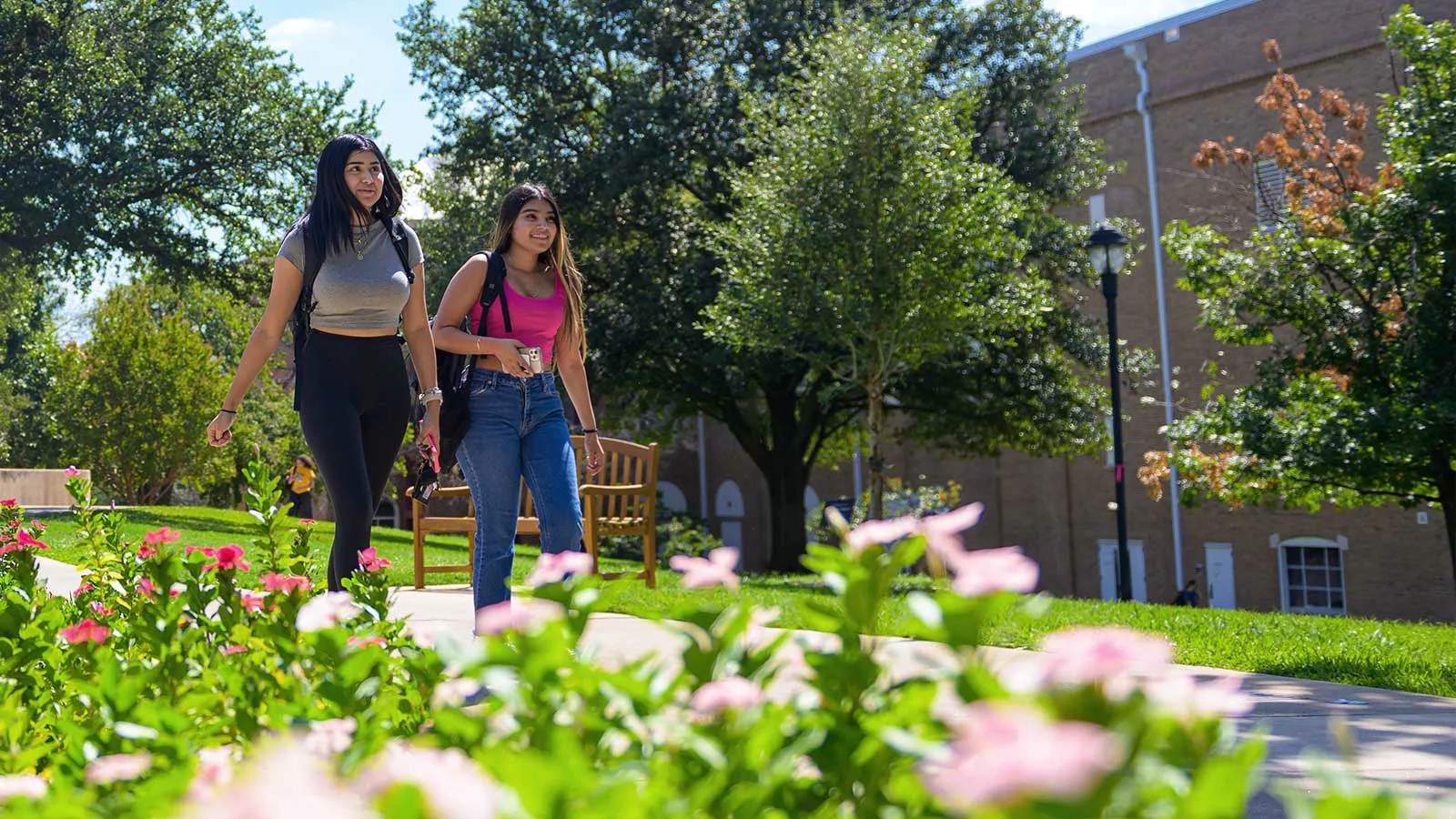 Two 鶹ýAV Students Walking down Redbud Lane