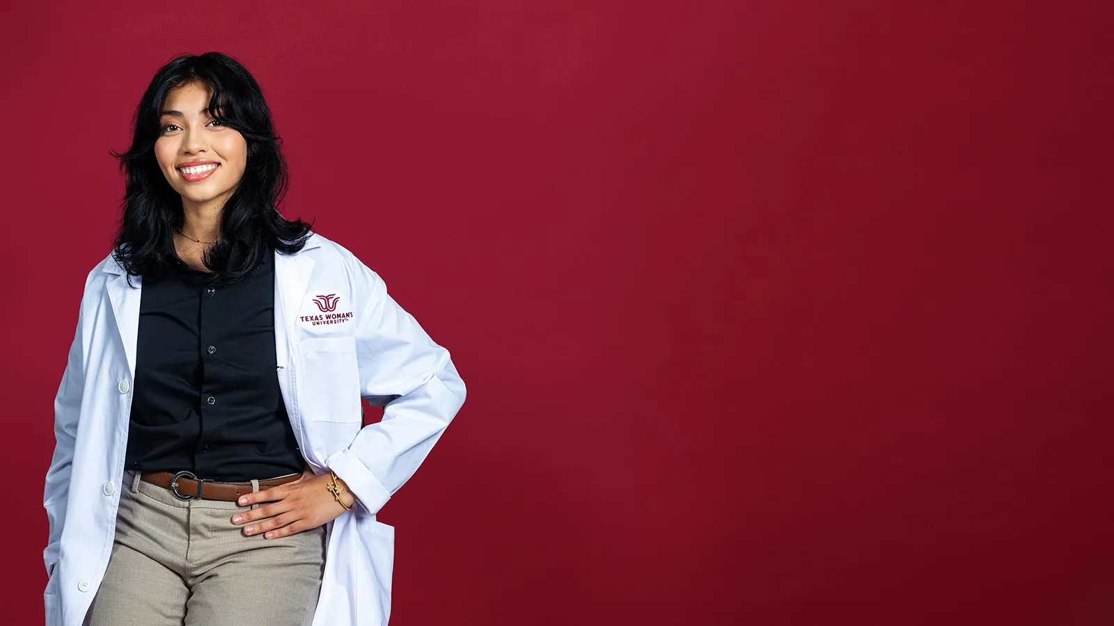 TWU student Rosemary Romero wears a lab coat with the university logo embroidered on it