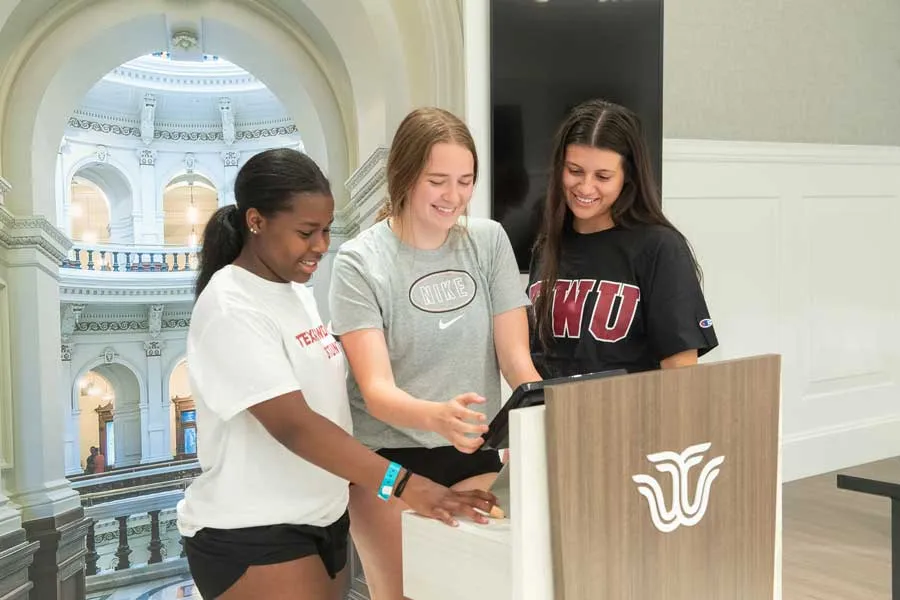 Three students in the Institute for Women's Leadership museum.