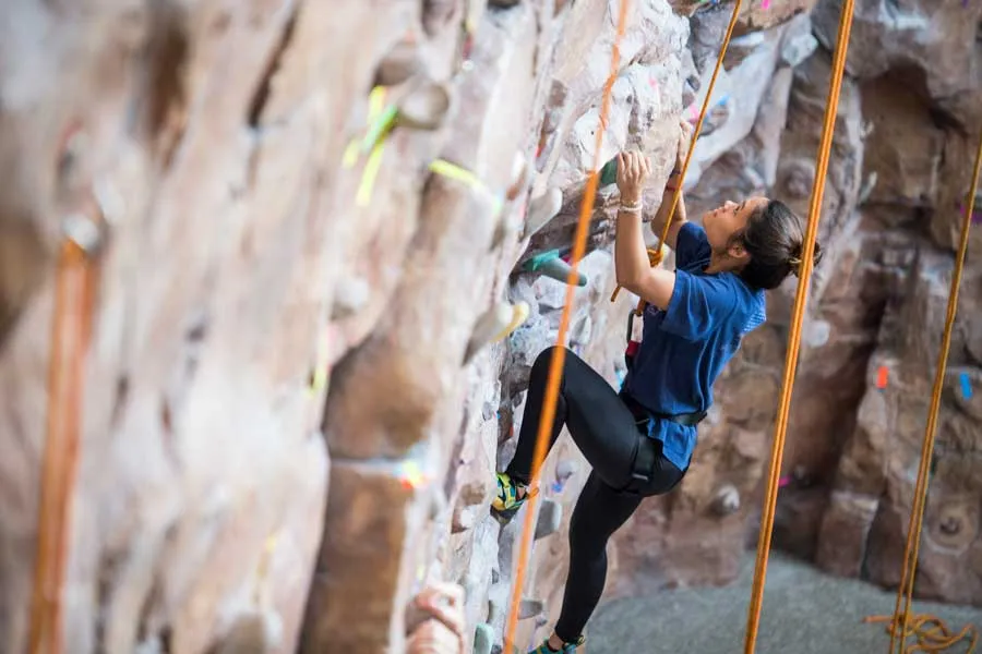 A climber on the Fit and Rec rock climbing wall.