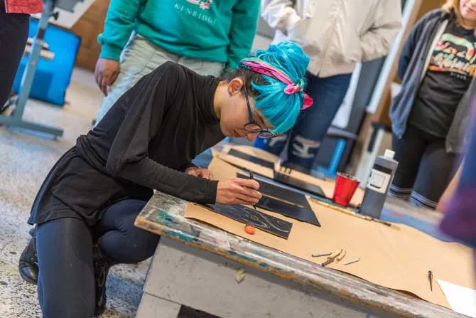 TWU student works in an art studio on a project