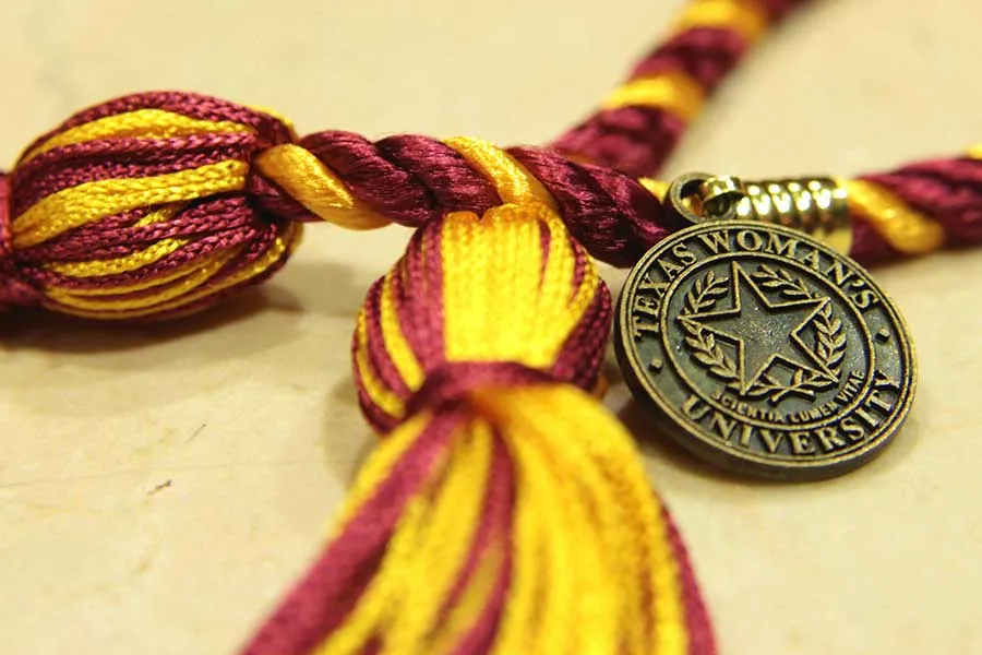 Maroon and gold graduation regalia cord