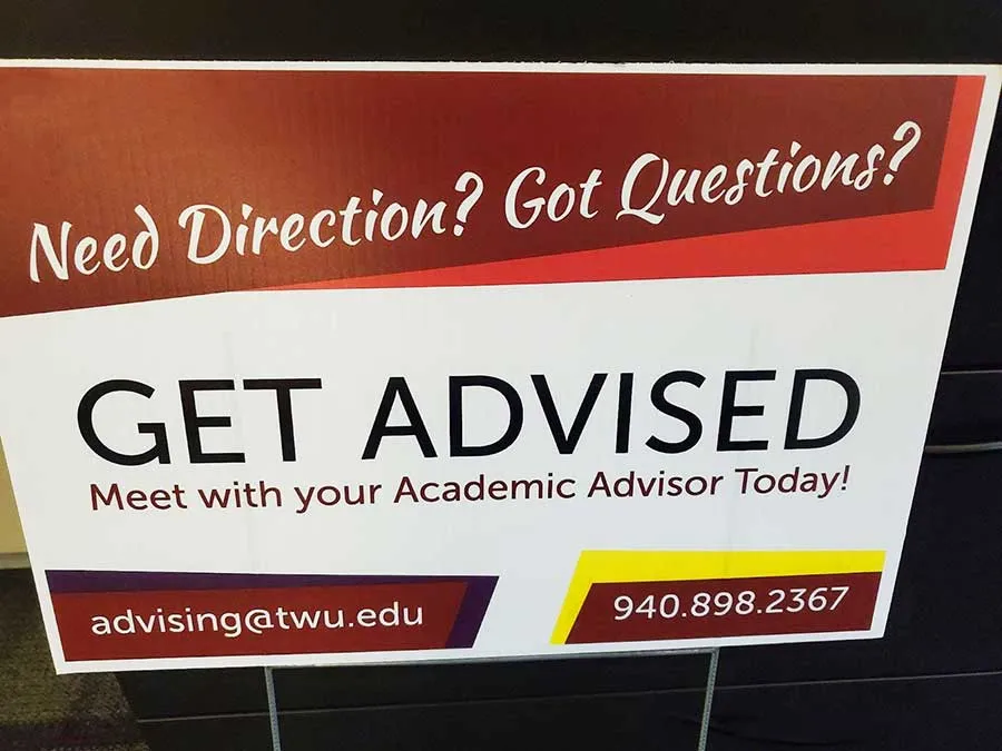 A sign that reads Need Direction? Got Questions? Get Advised. Meet with Your Academic Advisor Today! 