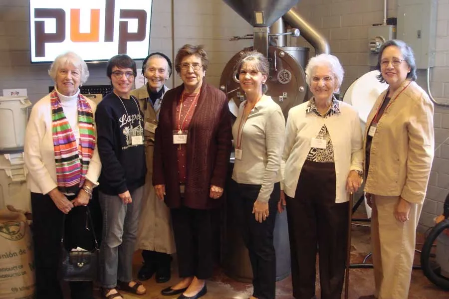 A group of TWU alumni visit a business titled 