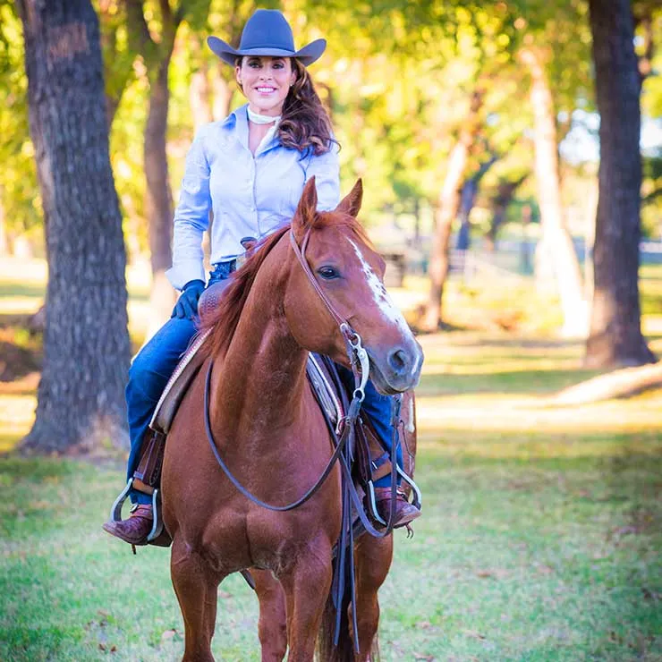 A portrait of Stacie McDavid riding a horse.
