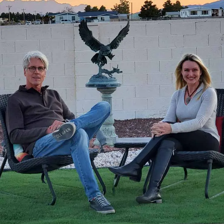 David and Jody Popple sitting by a sculpture