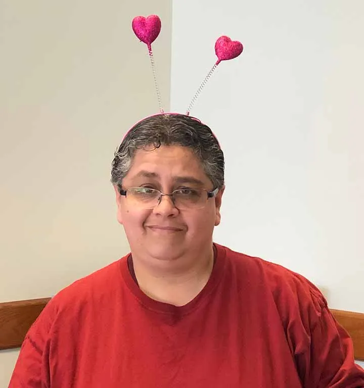 A TWU staff member with valentine hearts