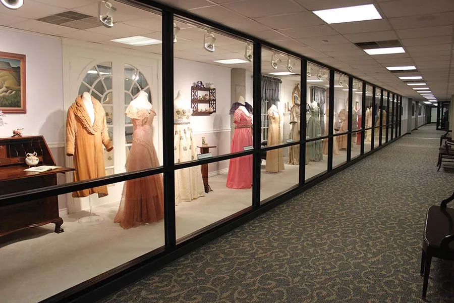 Some of the gowns in the Texas first ladies gown collection, displayed behind glass.