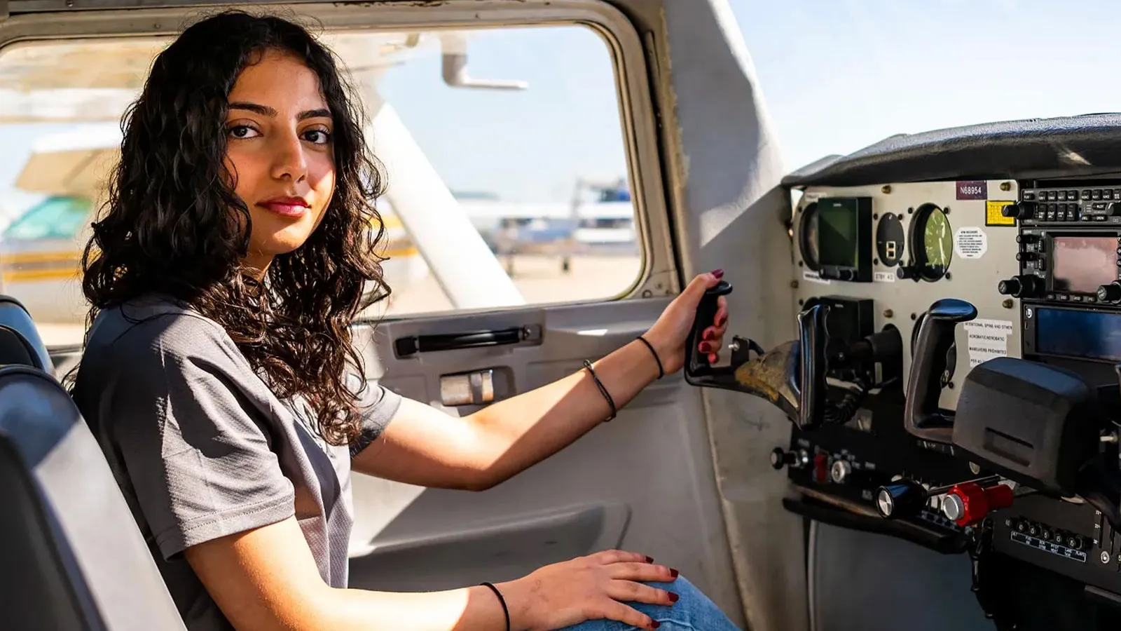 Danah Alramahi in the cockpit of an airplane 