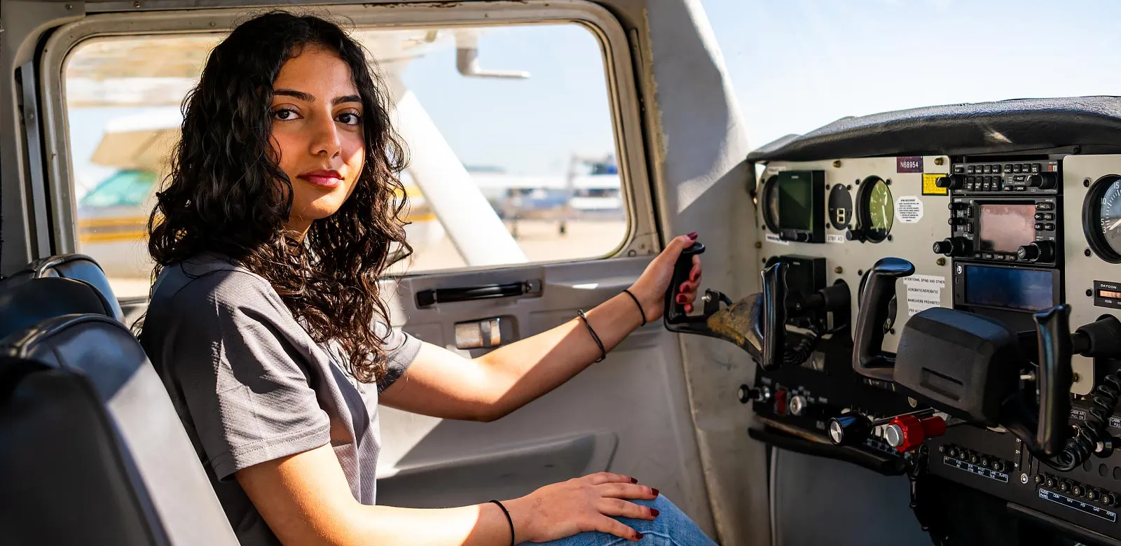 A student in the cockpit of an airplane