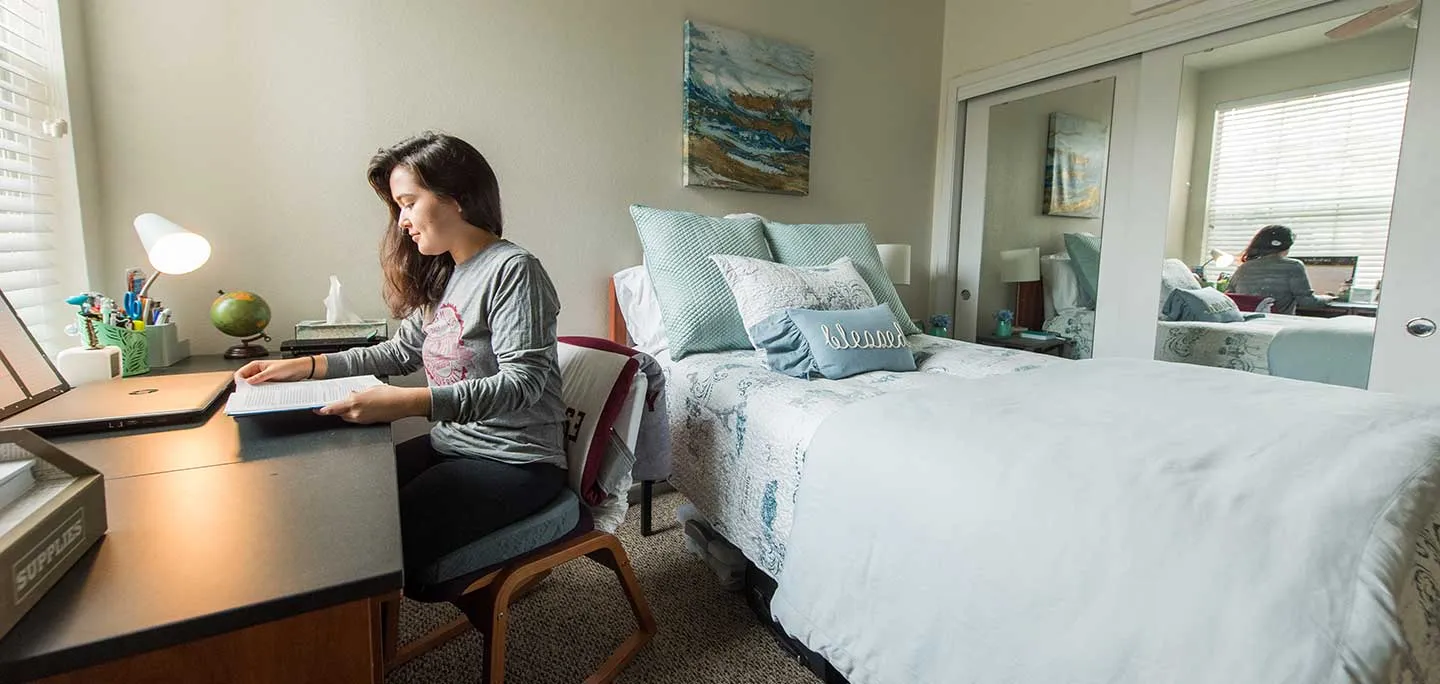 A TWU student studies in her bedroom in Lowry Woods.