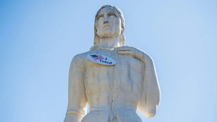 A close-up of the Pioneer Woman statue on the TWU Denton campus wearing a large 