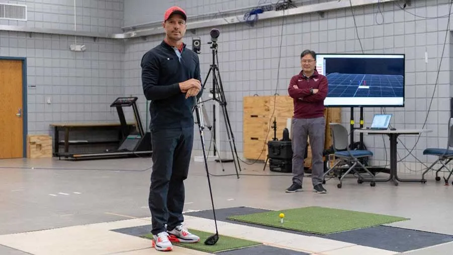 Chris Como, left, works with Young-Hoo Kwon, PhD, to collect golf swing data in the TWU kinesiology lab