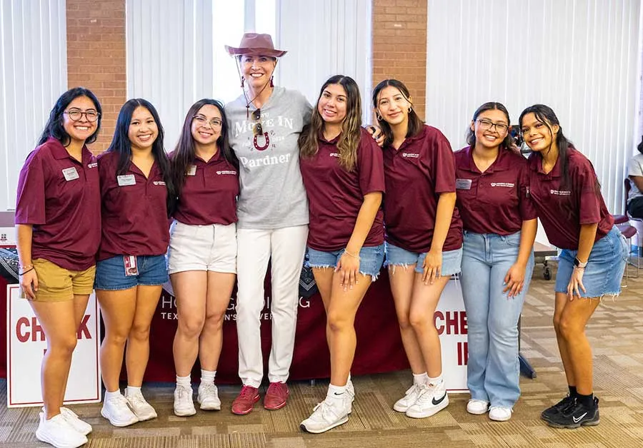 Chancellor Carine Feyten with students during Move-In Week on the Denton TWU campus