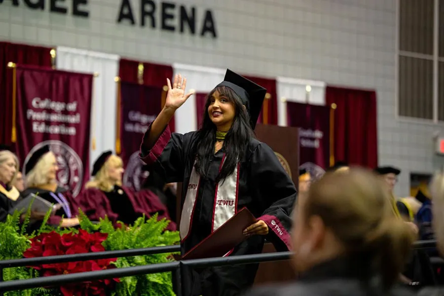 TWU graduate walks the aisle during Commencement