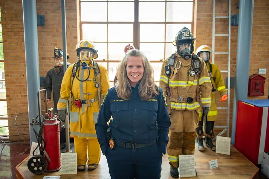 Denton Assistant Fire Marshal Megan Schuth stands with firefighters she works with