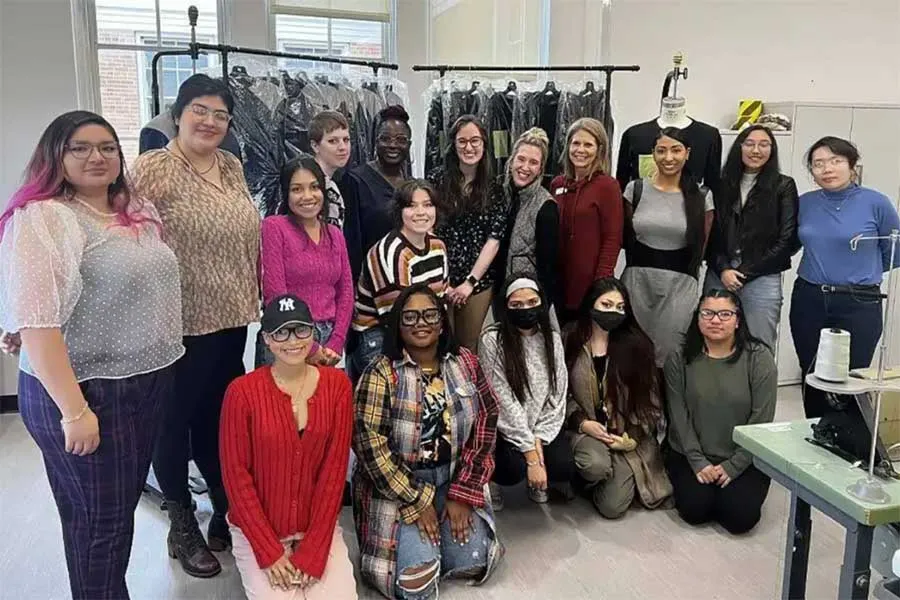TWU Fashion design students pose with garments they produced for men experiencing homelessness in Denton