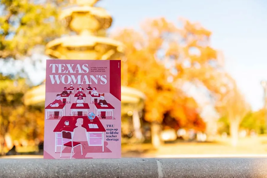 The latest issue of Texas Woman's magazine against a backdrop of the library fountain on the Denton campus