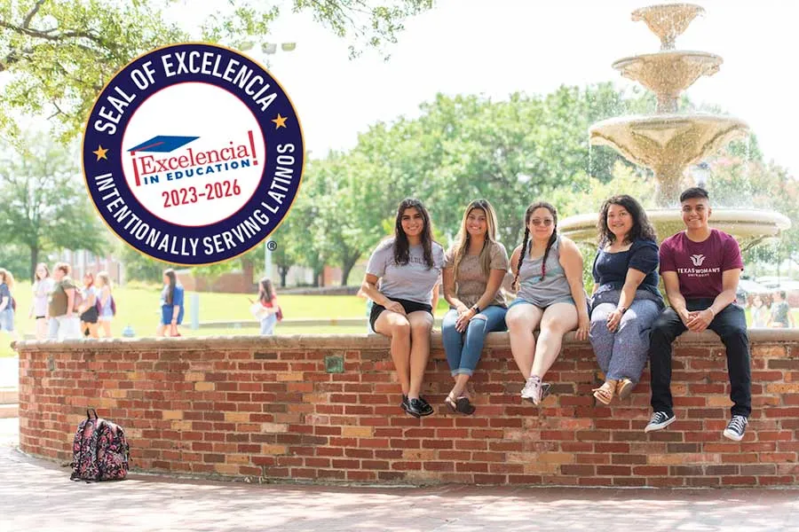 A group of TWU students sit together on the edge of the fountain at Blagg-Huey Library, with an image of the Seal of Excelencia on the upper left corner of the photo