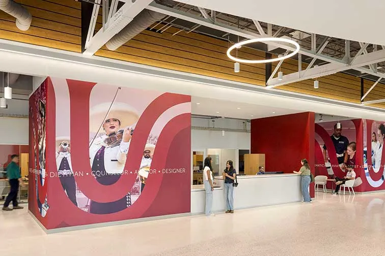 Students at a Brackenridge Hall front desk receiving assistance.
