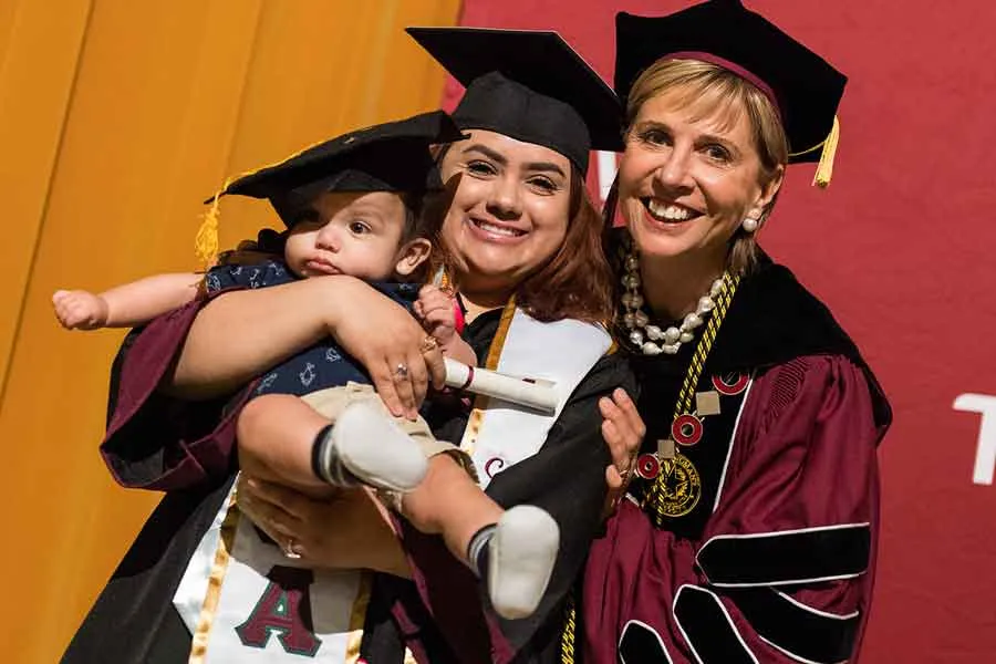TWU Parent with baby and TWU Chancellor and President 