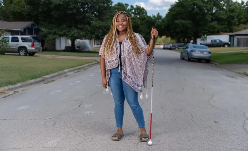 TWU student Demetria Ober stands in front of her Fort Worth home. 