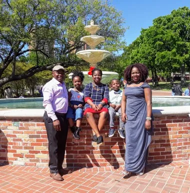 Esther Ajayi-Lowo's family at the TWU library fountain