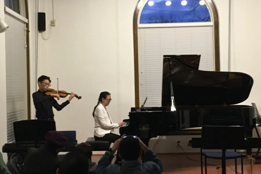 TWU adult beginner piano student Qian Hu accompanied by her son, Ocean Xie, on violin.