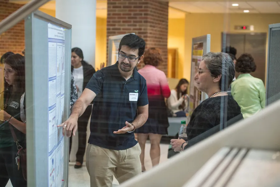 A student presents a research poster during TWU's Celebration of Science event