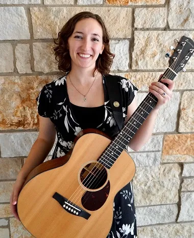 Music therapy student Kathleen Montes with a guitar