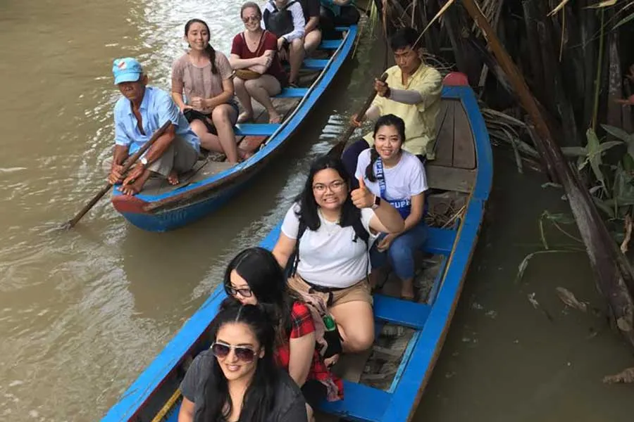 TWU students floating down the Tien Giang river, part of the Mekong river tributaries.