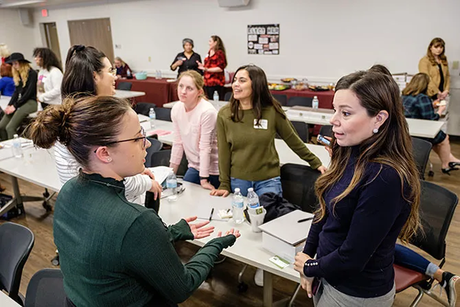 A group of young women in an animated workshop discussion