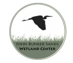 John Bunker Sands Logo with Crane flying over grass.