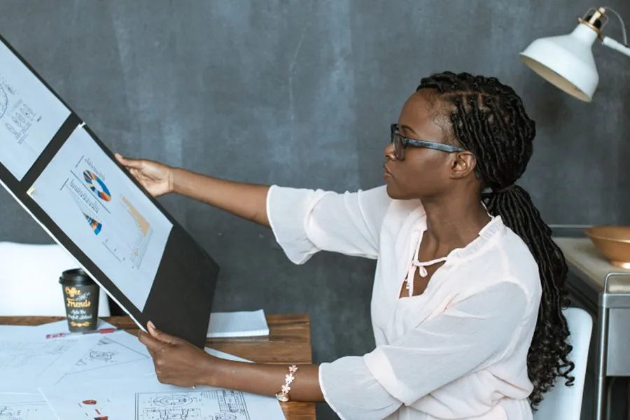 A woman business owner studies analytical data for a presentation