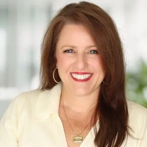 a headshot of candace rempe in a bright white office