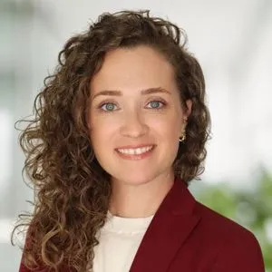 a headshot of jessica walling in a bright white office