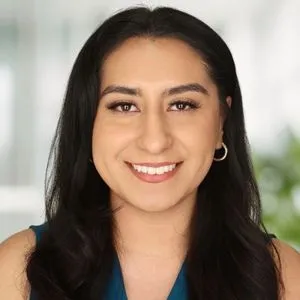 a headshot of sarallyn medrano in a bright white offices