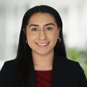 a headshot of sarallyn medrano in a bright white office