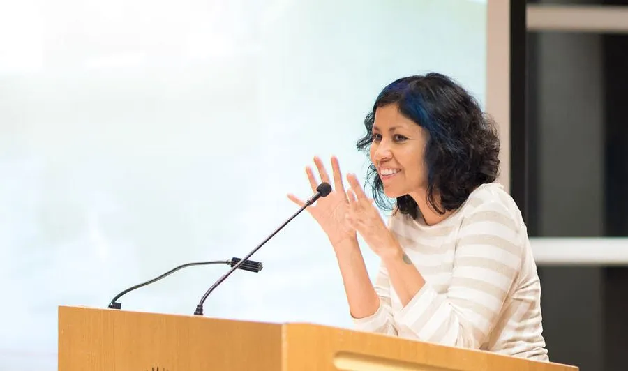 2020 Texas Poet Laureate Emmy Perez speaking at a podium