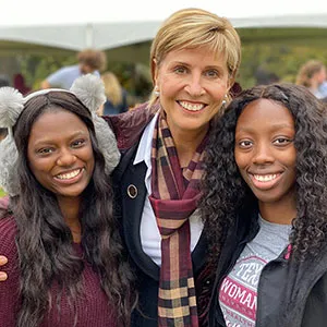 Chancellor Carine Feyten smiles with two TWU students