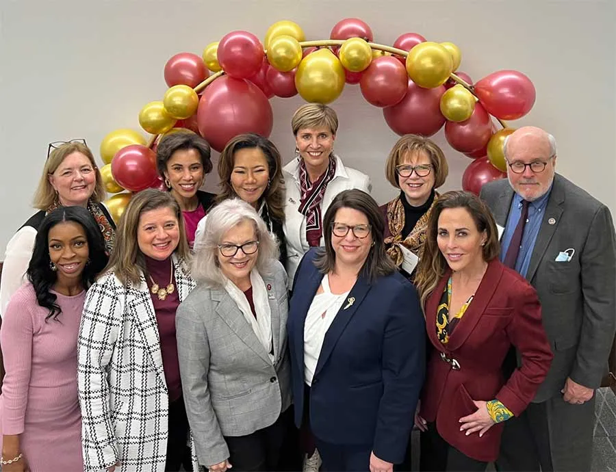 Chancellor Feyten with the TWU 2021-2022 Board of Directors beneath an arch of balloons