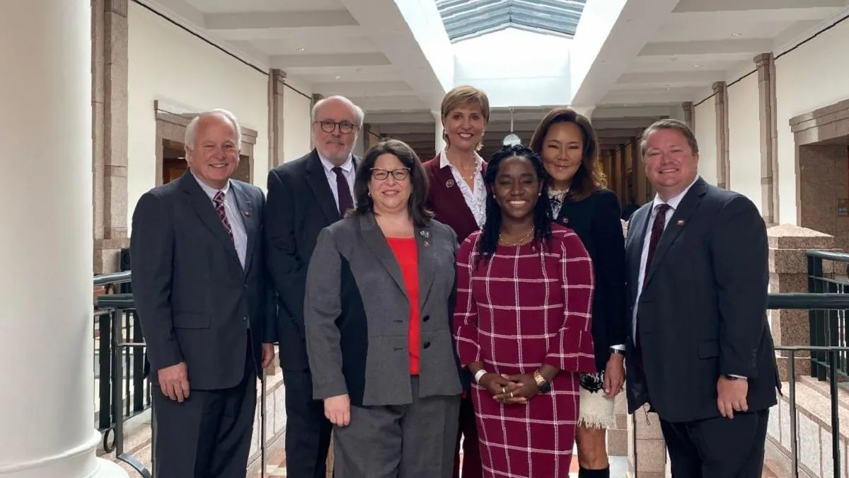 From left, Dr. Brian May, Regent Bob Hyde, Regent Jill Jester, Chancellor Carine Feyten, Student Regent Dawna-Diamond Tyson, Regent Kathleen Wu and Kevin Cruser inside the Texas capitol building.